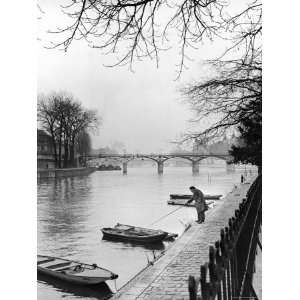  Man Near Rowboats on the Banks of Seine River Stretched 