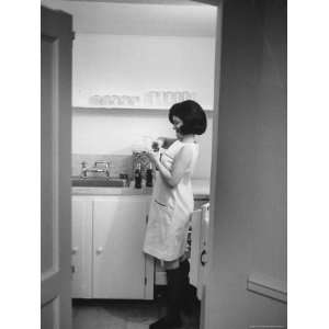  Lucy Baines Johnson at Home in Kitchen Opening a Bottle 